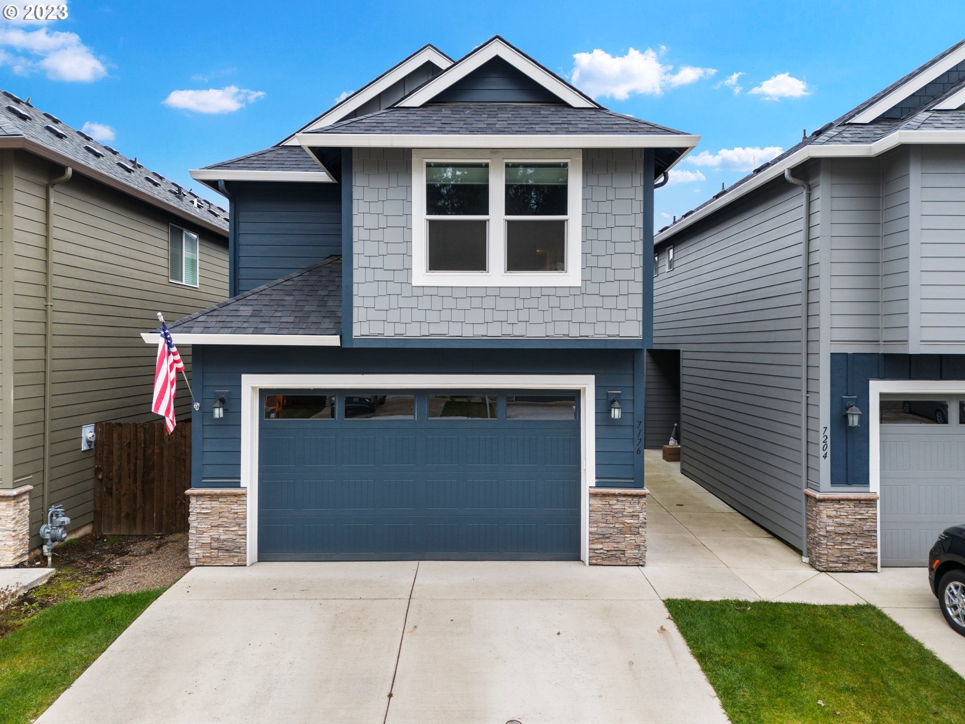 7176 South 13th Street Ridgefield, WA 98642 - Photo 1 of 46 a front view of a house with a yard and garage