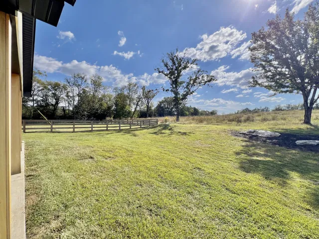 a spacious bedroom with a bed and a chandelier