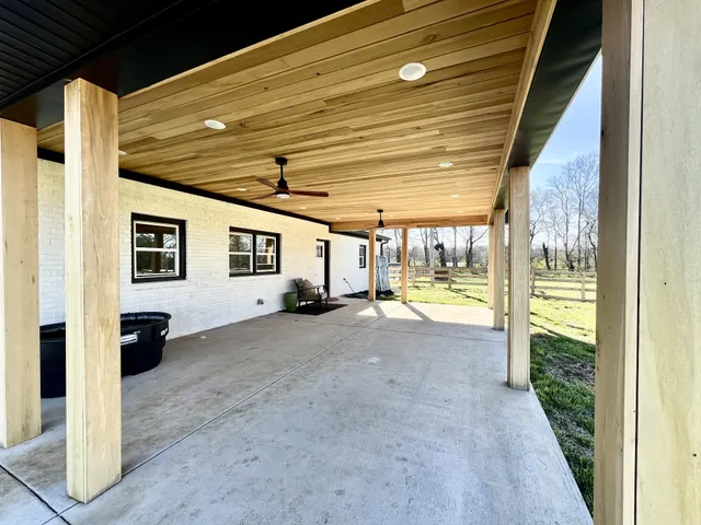 a view of a livingroom with an entryway and wooden floor
