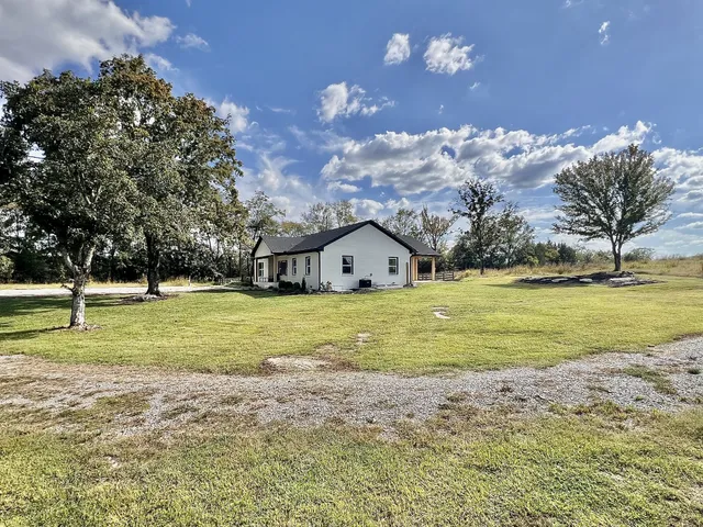 a view of house with garden space and swimming pool