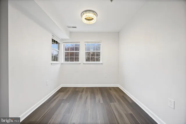 a view of a room with wooden floor and windows