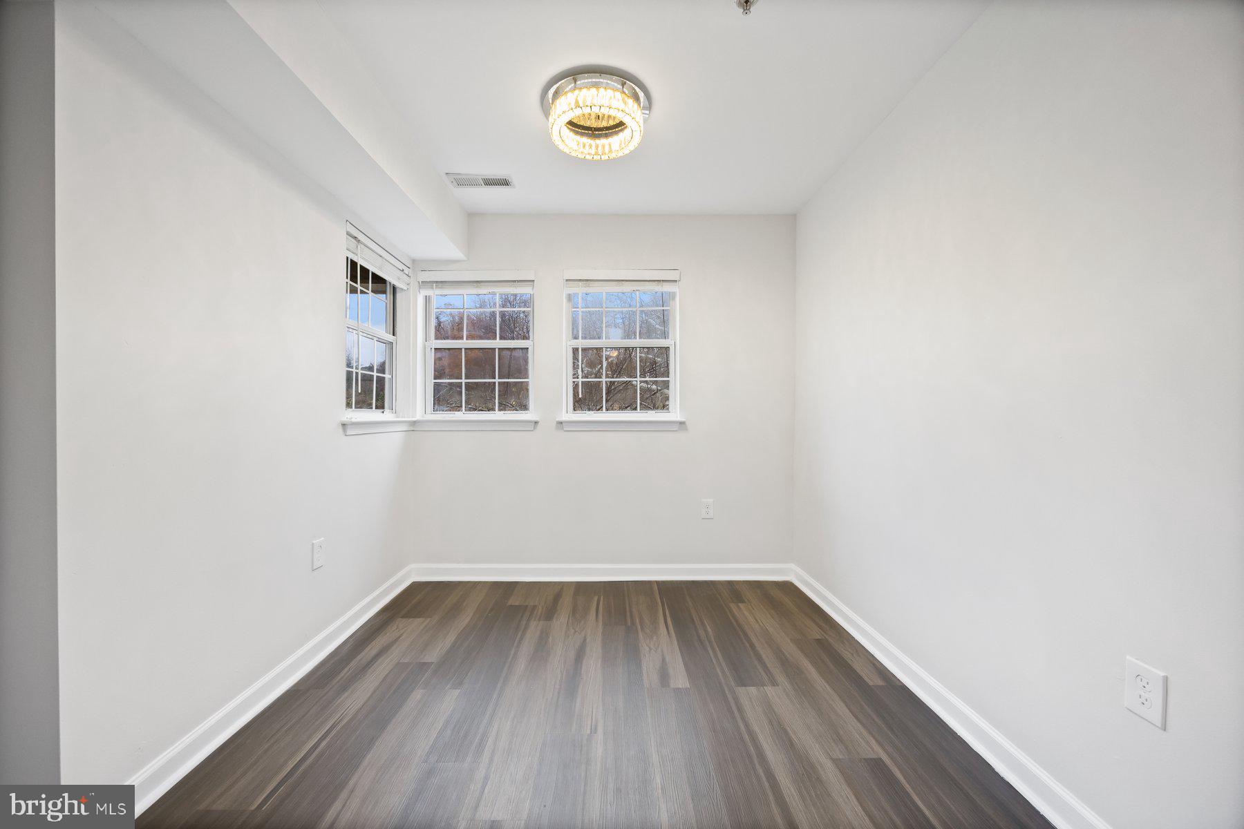 8393 Montgomery Run Road, Unit H Ellicott City, MD 21043 - Photo 11 of 30 a view of a room with wooden floor and windows
