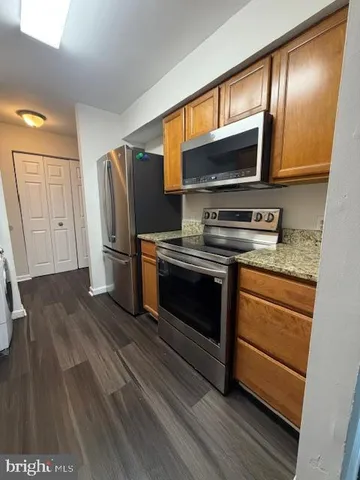 a kitchen with stainless steel appliances a stove and a refrigerator