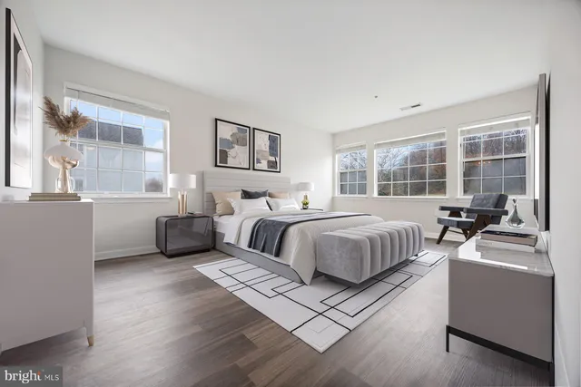 a bedroom with a bed and a large window