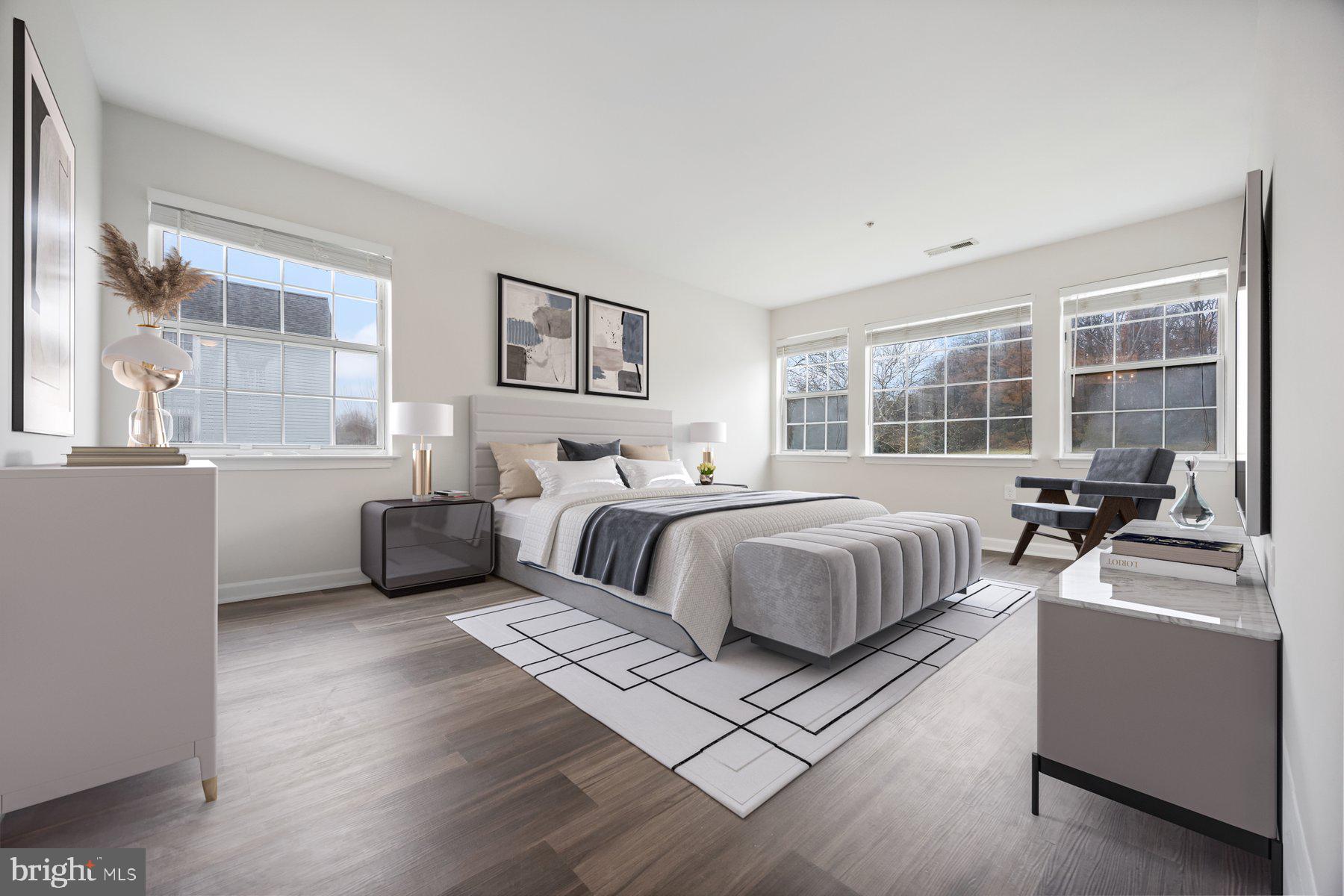 8393 Montgomery Run Road, Unit H Ellicott City, MD 21043 - Photo 18 of 30 a bedroom with a bed and a large window