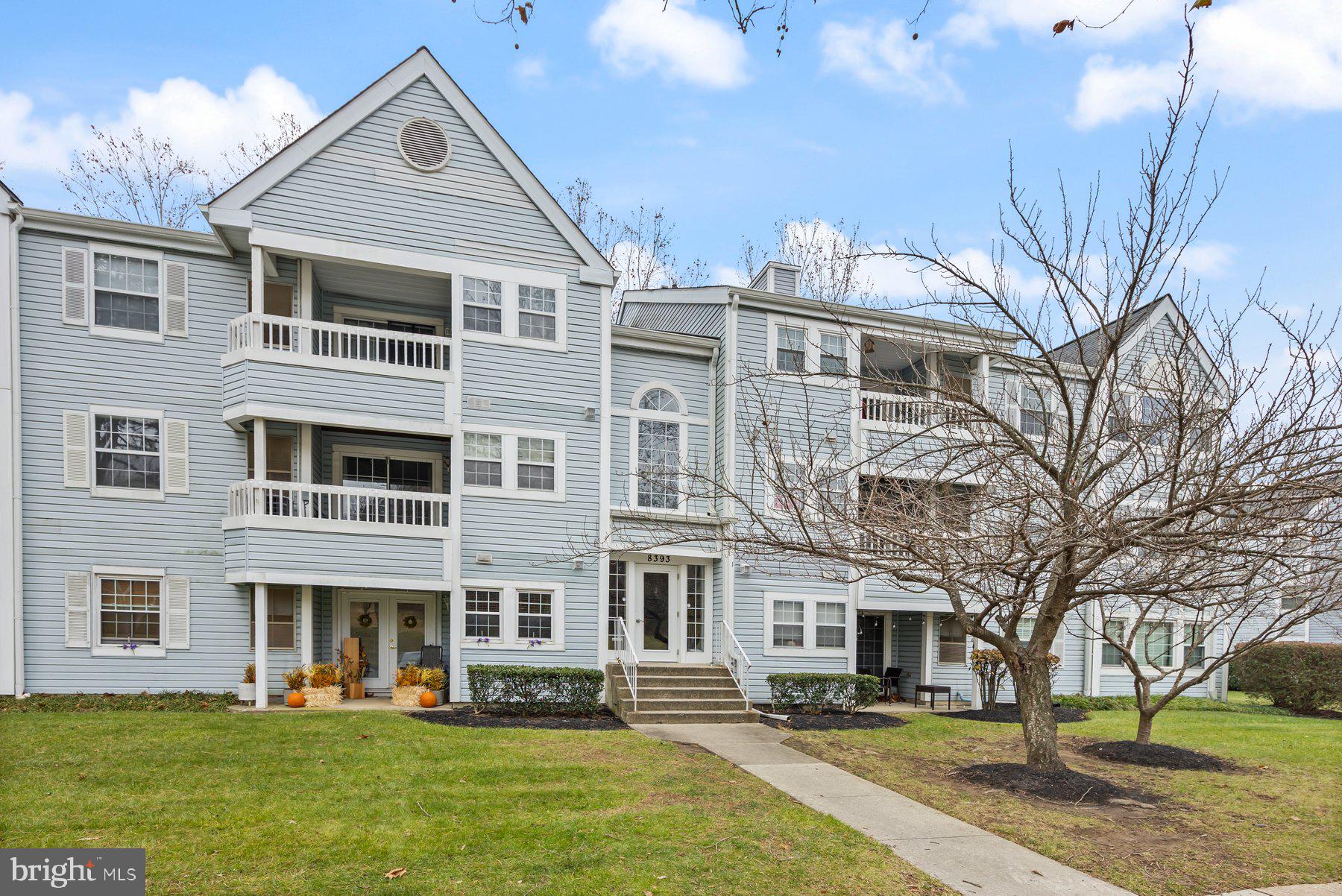 8393 Montgomery Run Road, Unit H Ellicott City, MD 21043 - Photo 2 of 30 a front view of residential houses with yard and green space