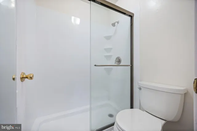 a white toilet sitting next to a bath tub