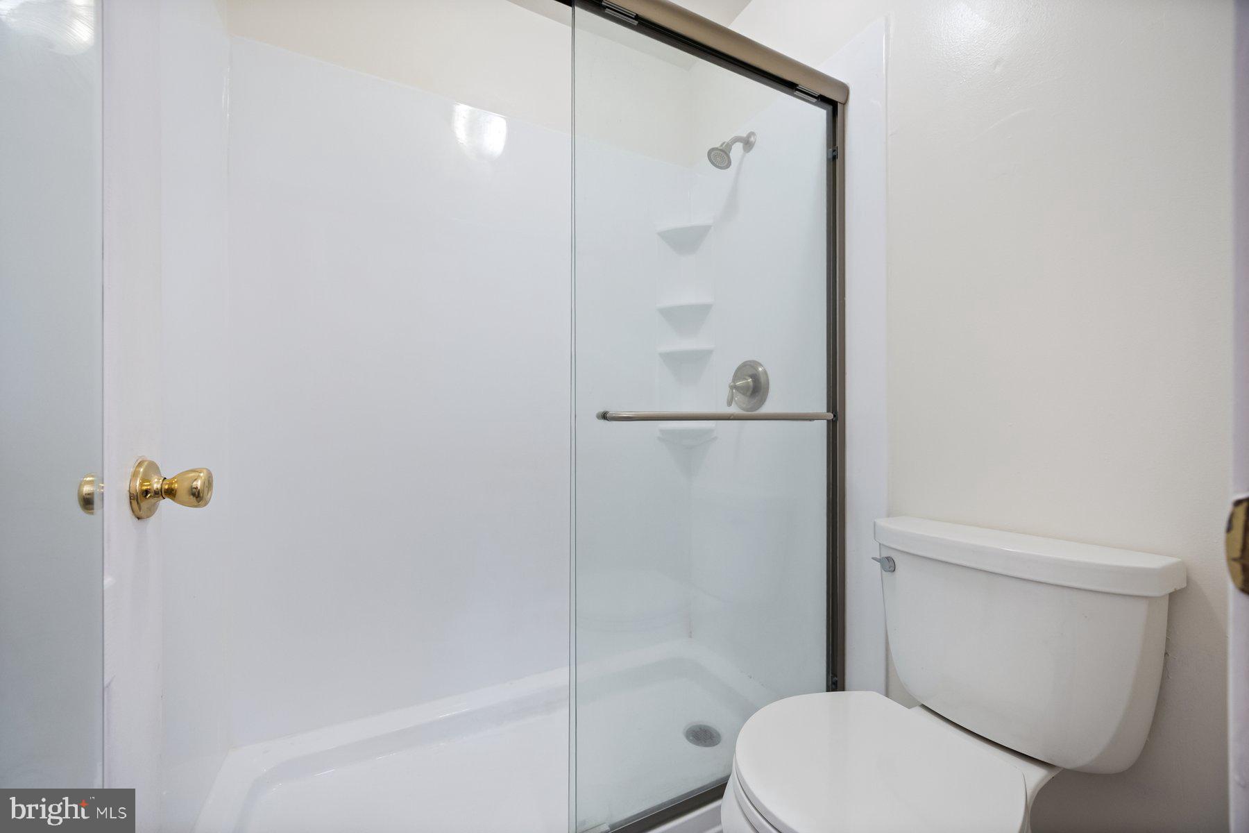 8393 Montgomery Run Road, Unit H Ellicott City, MD 21043 - Photo 24 of 30 a white toilet sitting next to a bath tub