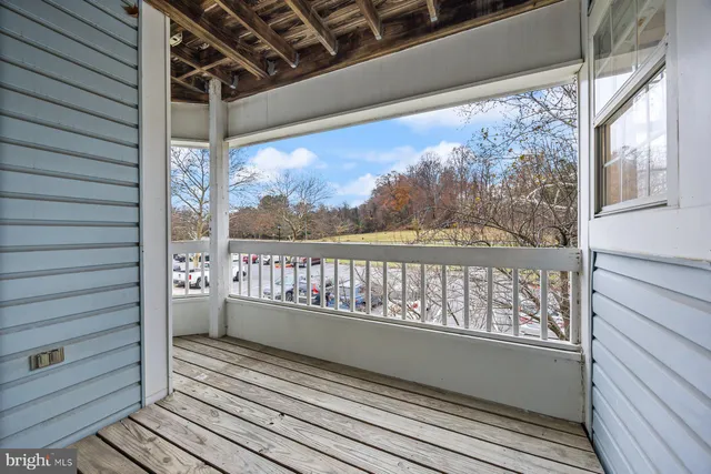 a view of a balcony with wooden floor