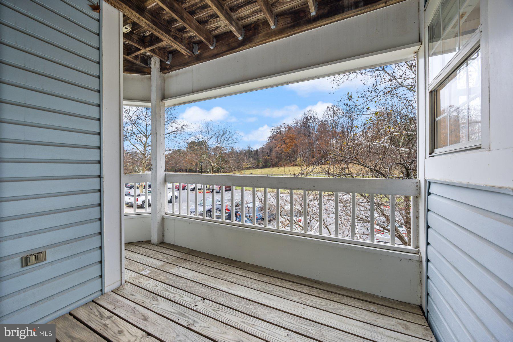 8393 Montgomery Run Road, Unit H Ellicott City, MD 21043 - Photo 29 of 30 a view of a balcony with wooden floor