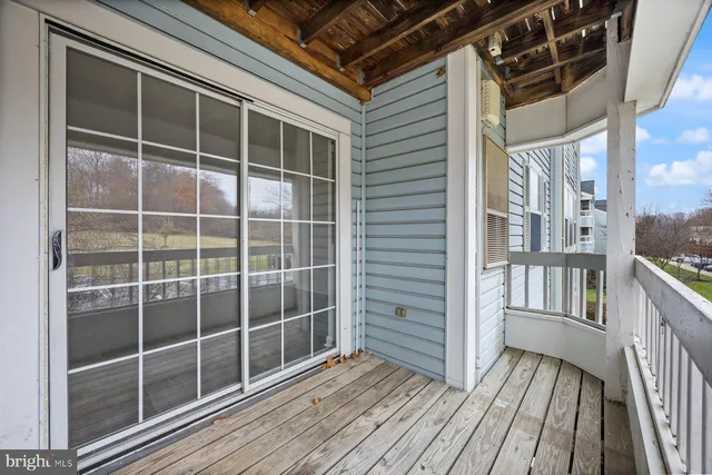a view of a balcony with wooden floor