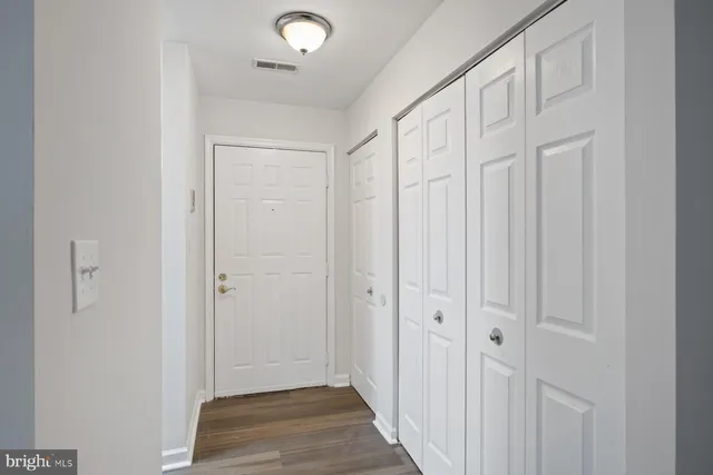 a view of a hallway with wooden floor