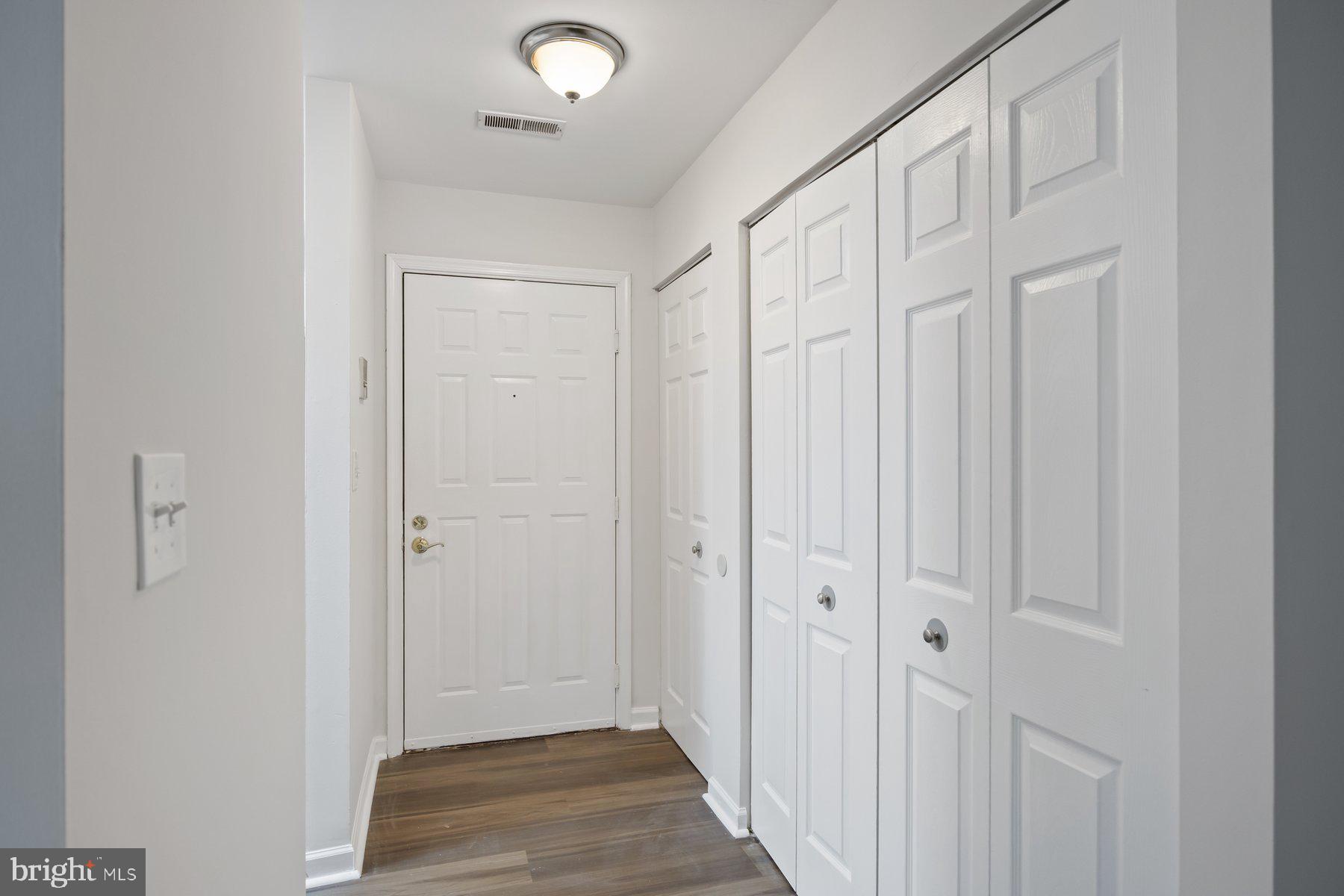 8393 Montgomery Run Road, Unit H Ellicott City, MD 21043 - Photo 4 of 30 a view of a hallway with wooden floor