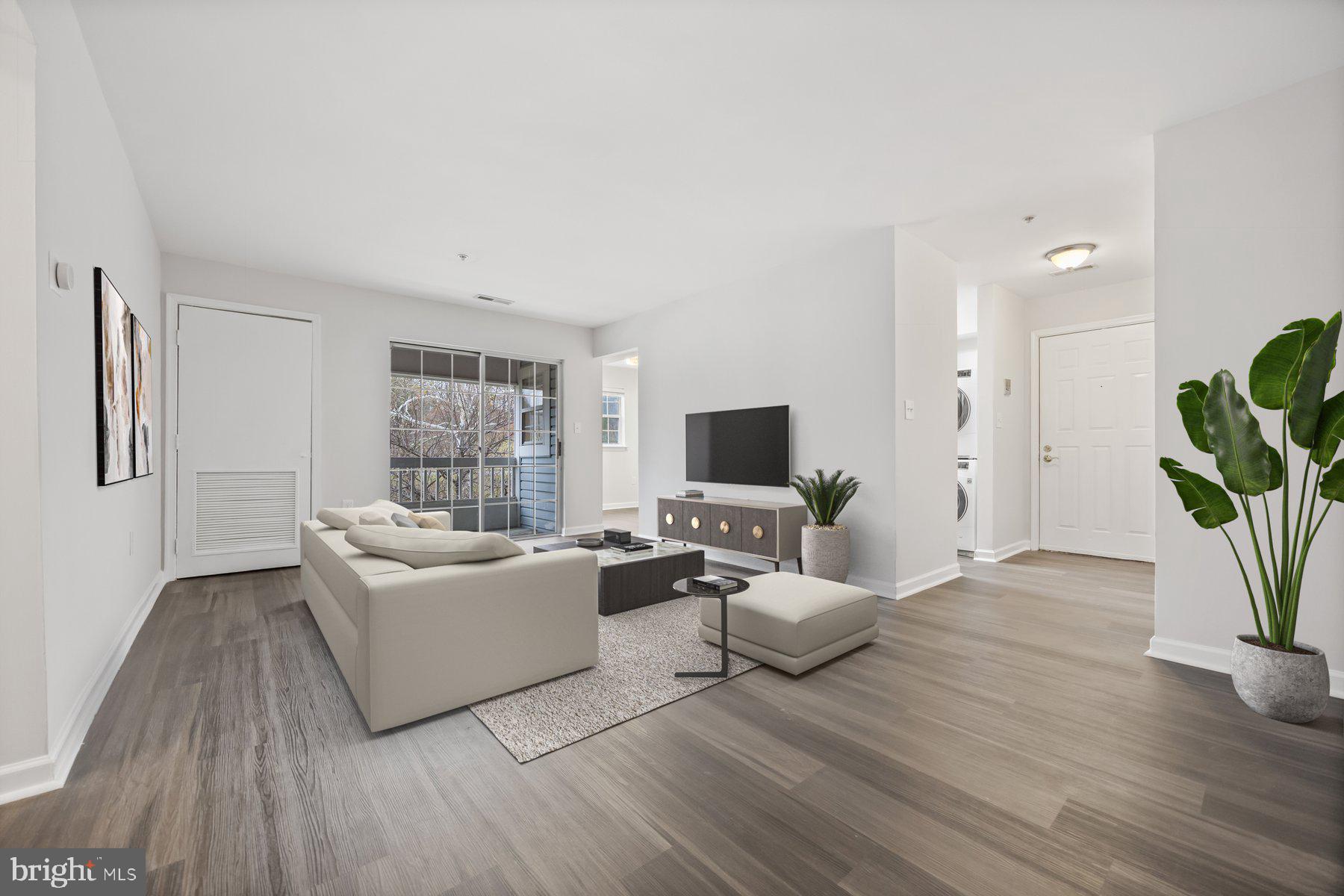 8393 Montgomery Run Road, Unit H Ellicott City, MD 21043 - Photo 5 of 30 a living room with furniture and a flat screen tv