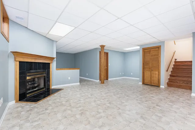 a view of empty room with a fireplace