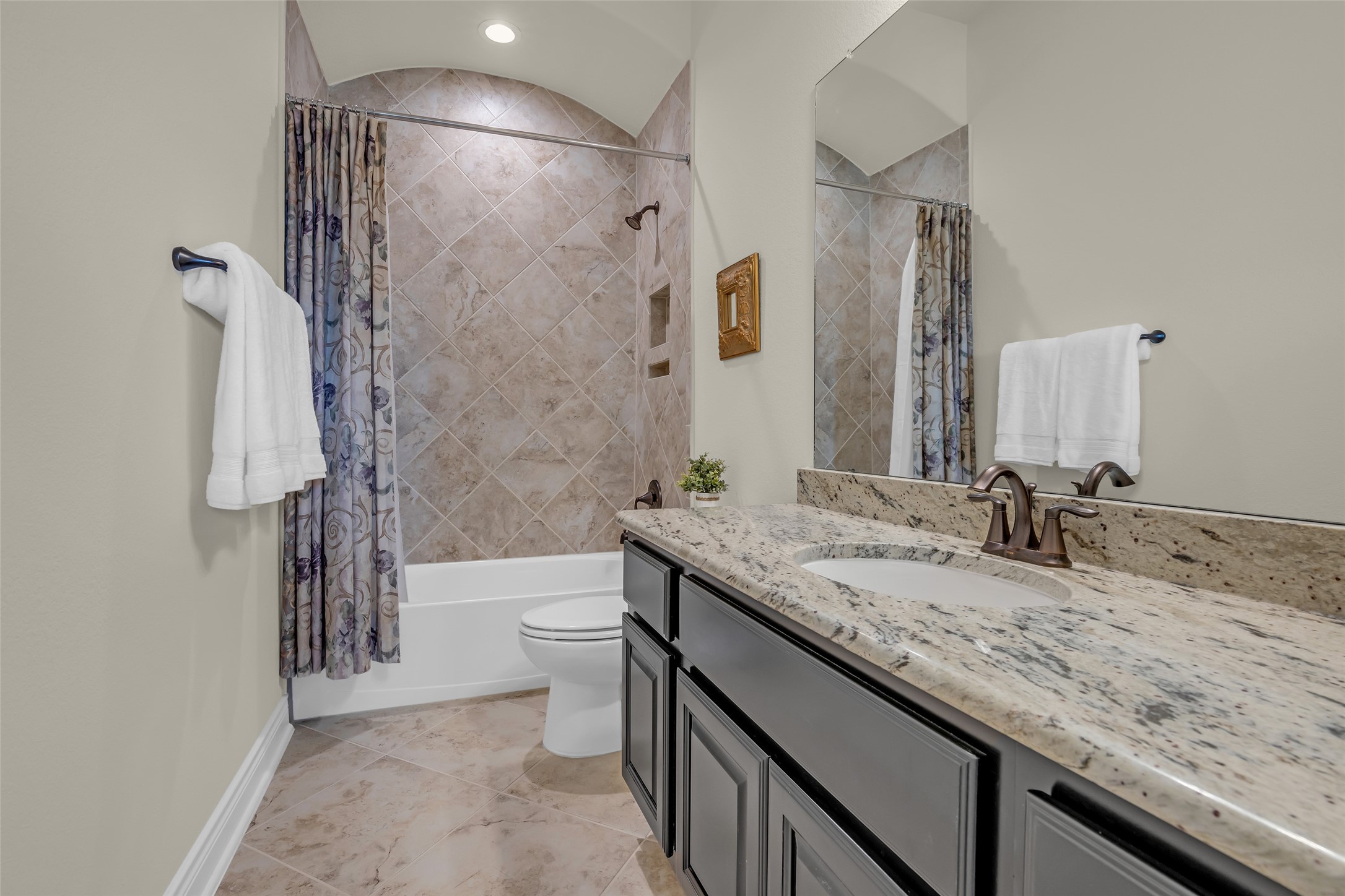 14003 South Evergreen Ridge Court Conroe, TX 77384 - Photo 9 of 43 Private en-suite bath with granite vanity and tiled tub/shower surround.