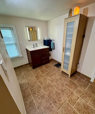 a bathroom with a mirror and a sink