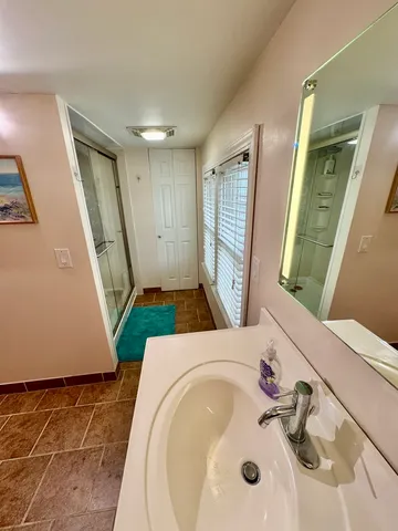 a bathroom with a sink mirror and a toilet