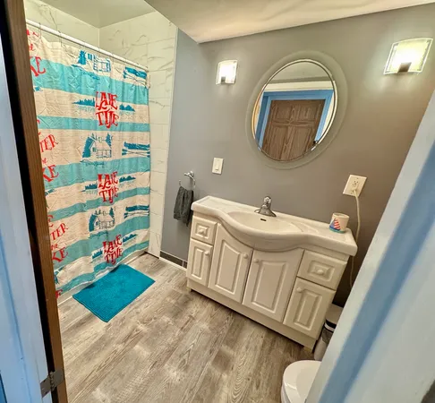 a bathroom with a sink mirror and vanity