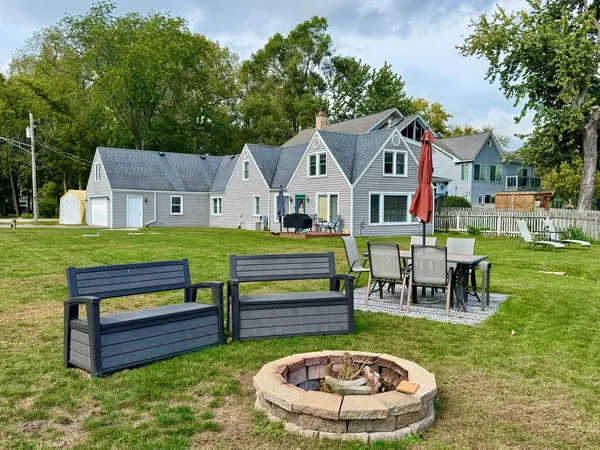 a front view of a house with a garden and outdoor seating