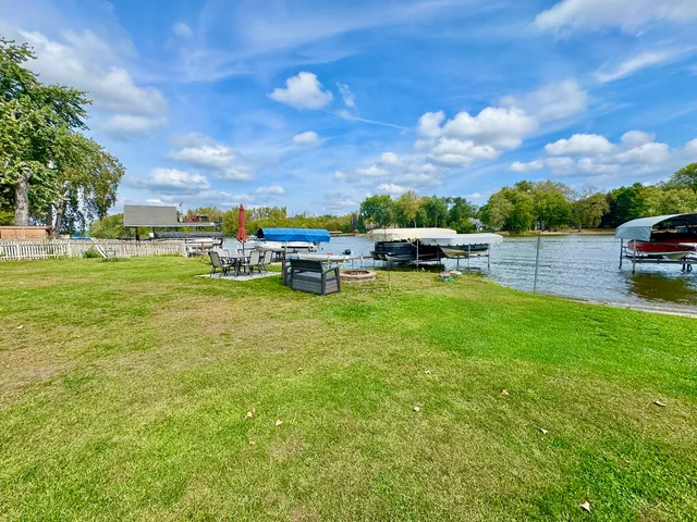 a view of a swimming pool and lounge chairs in the garden