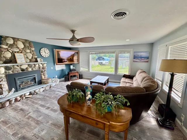 a living room with fireplace furniture and a flat screen tv