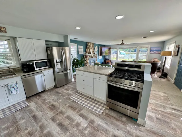 a kitchen with stainless steel appliances a stove a refrigerator and a sink
