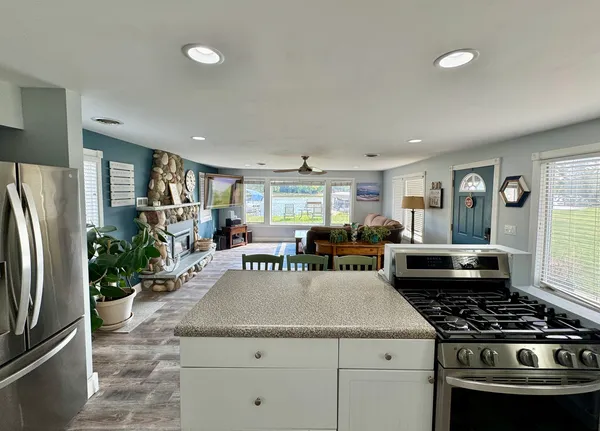 a kitchen with granite countertop a stove and refrigerator