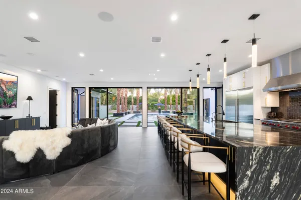 a kitchen with granite countertop a table and chairs