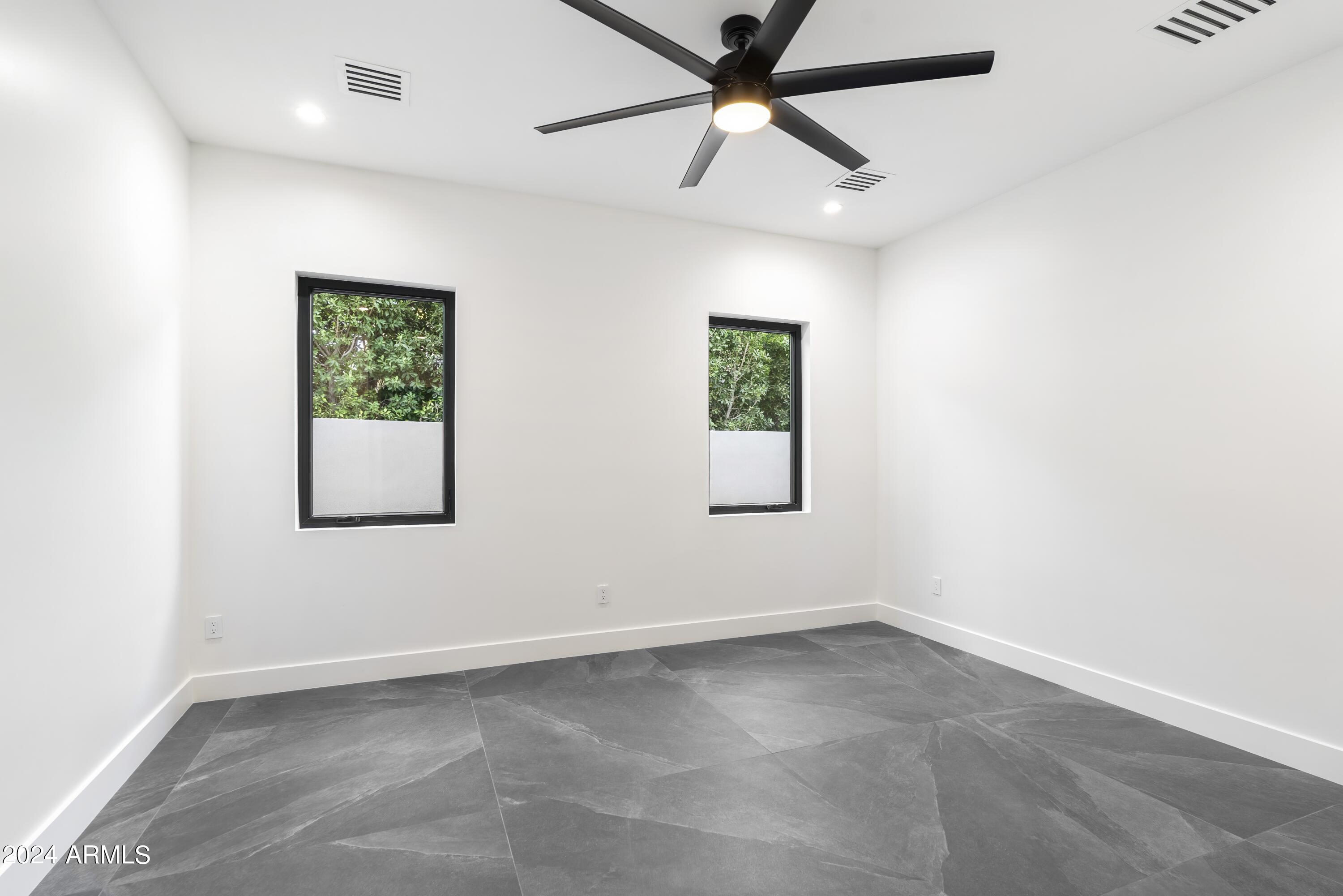 8037 North 7th Avenue Phoenix, AZ 85021 - Photo 25 of 40 an empty room with a window and a fan