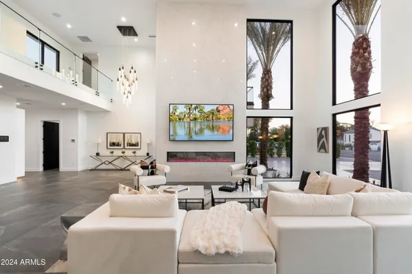 a living room with fireplace furniture and a large window