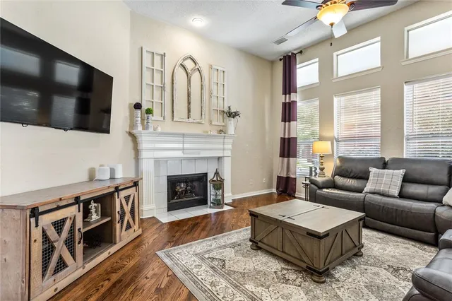 a living room with furniture a flat screen tv and a fireplace