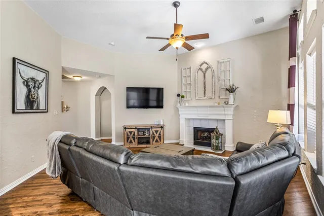a living room with furniture fireplace and flat screen tv