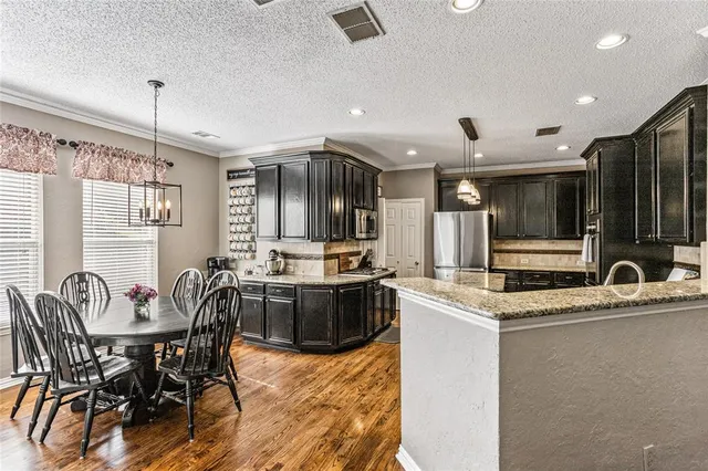 a kitchen with a table and chairs in it