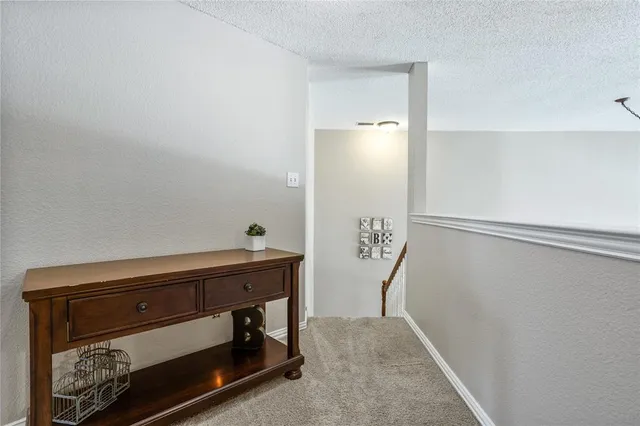 a room with a table and potted plant