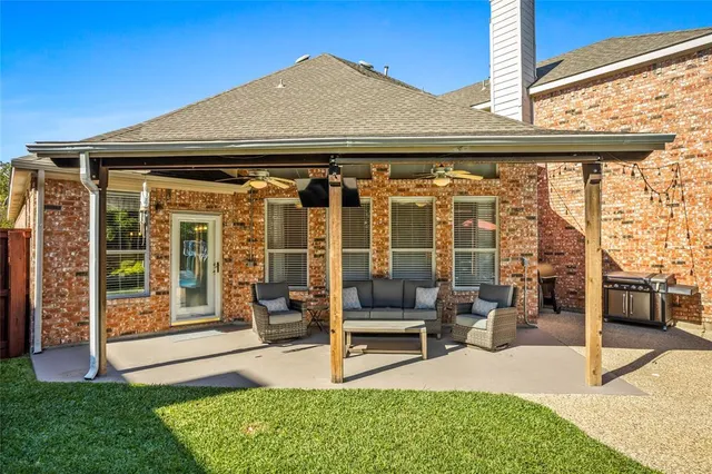 a view of house with backyard outdoor seating and barbeque oven