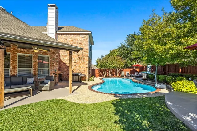 a view of a backyard with sitting area