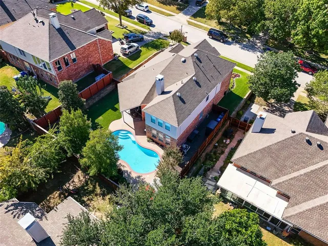 an aerial view of a house with a yard