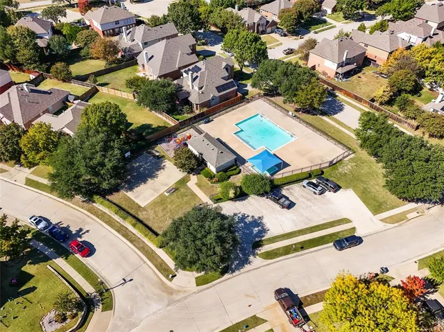 an aerial view of a house with a swimming pool and outdoor seating