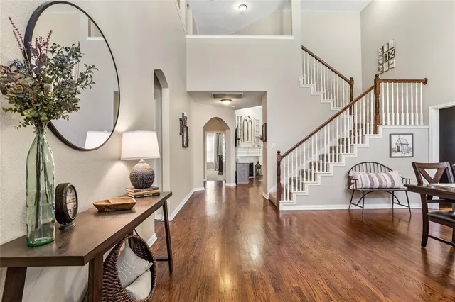 a view of entryway and hall with wooden floor