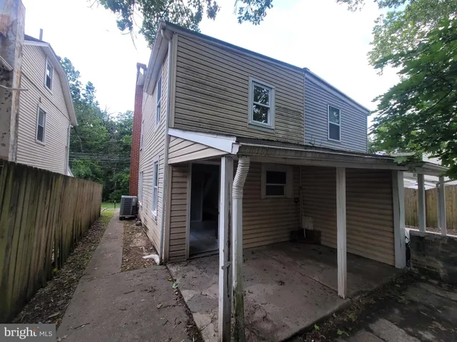 a view of a house with backyard and trees