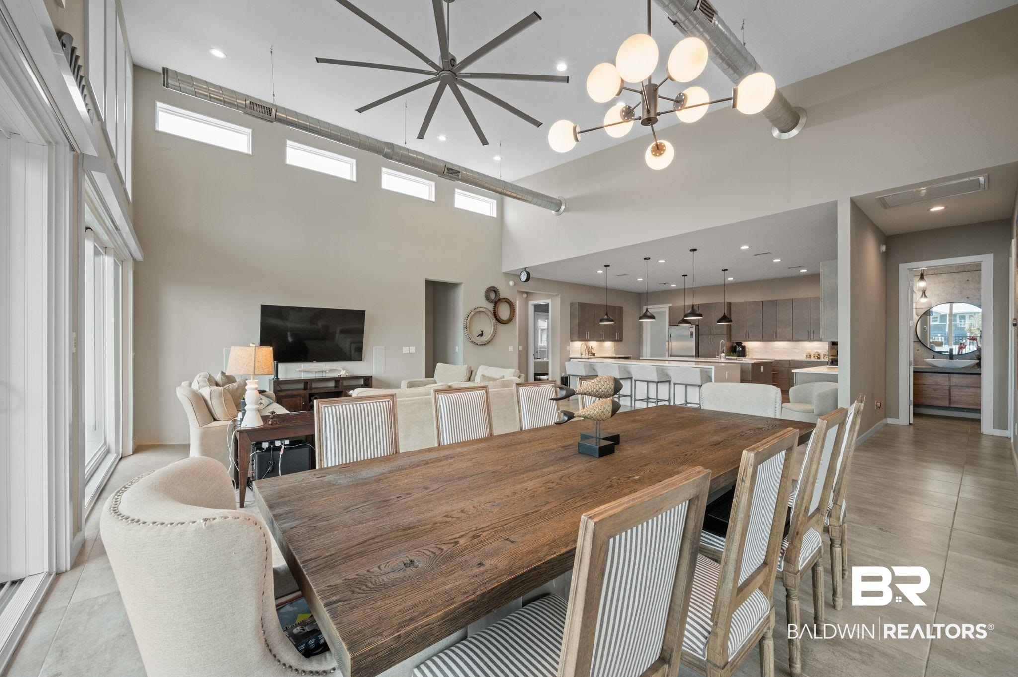 3840 Cotton Way Orange Beach, AL 36561 - Photo 9 of 75 Dining room with a towering ceiling and an inviting chandelier