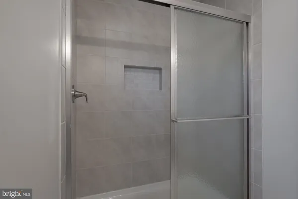 a bathroom with a glass shower door