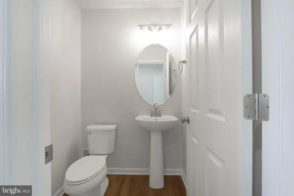 a bathroom with a toilet a sink and mirror