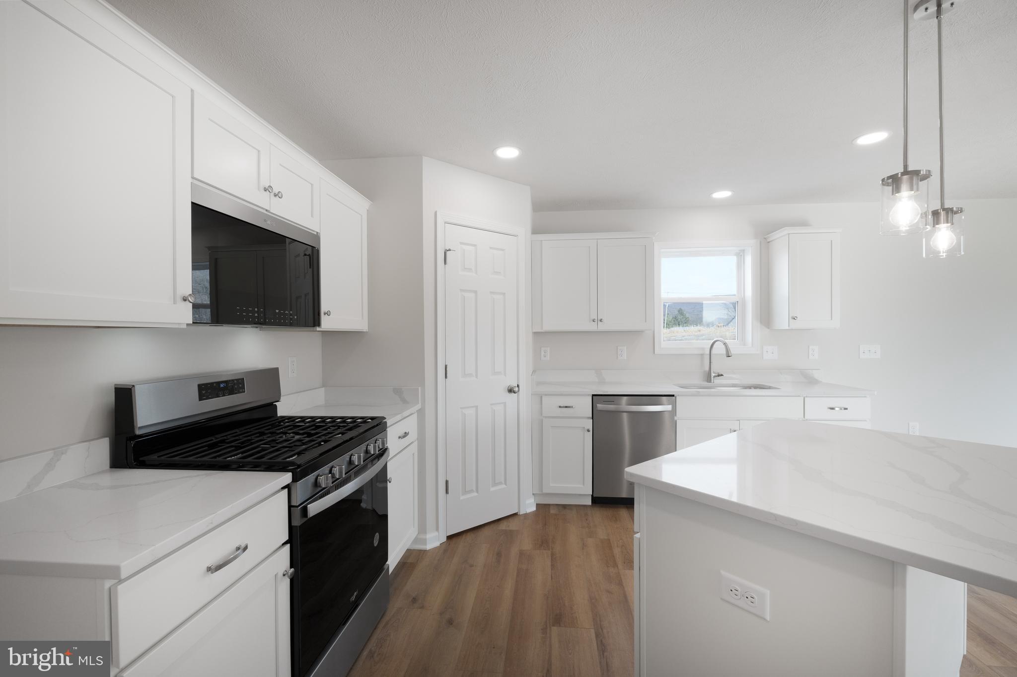 170 Ten Point Path Bellefonte, PA 16823 - Photo 8 of 45 a kitchen with a sink a stove a microwave and cabinets