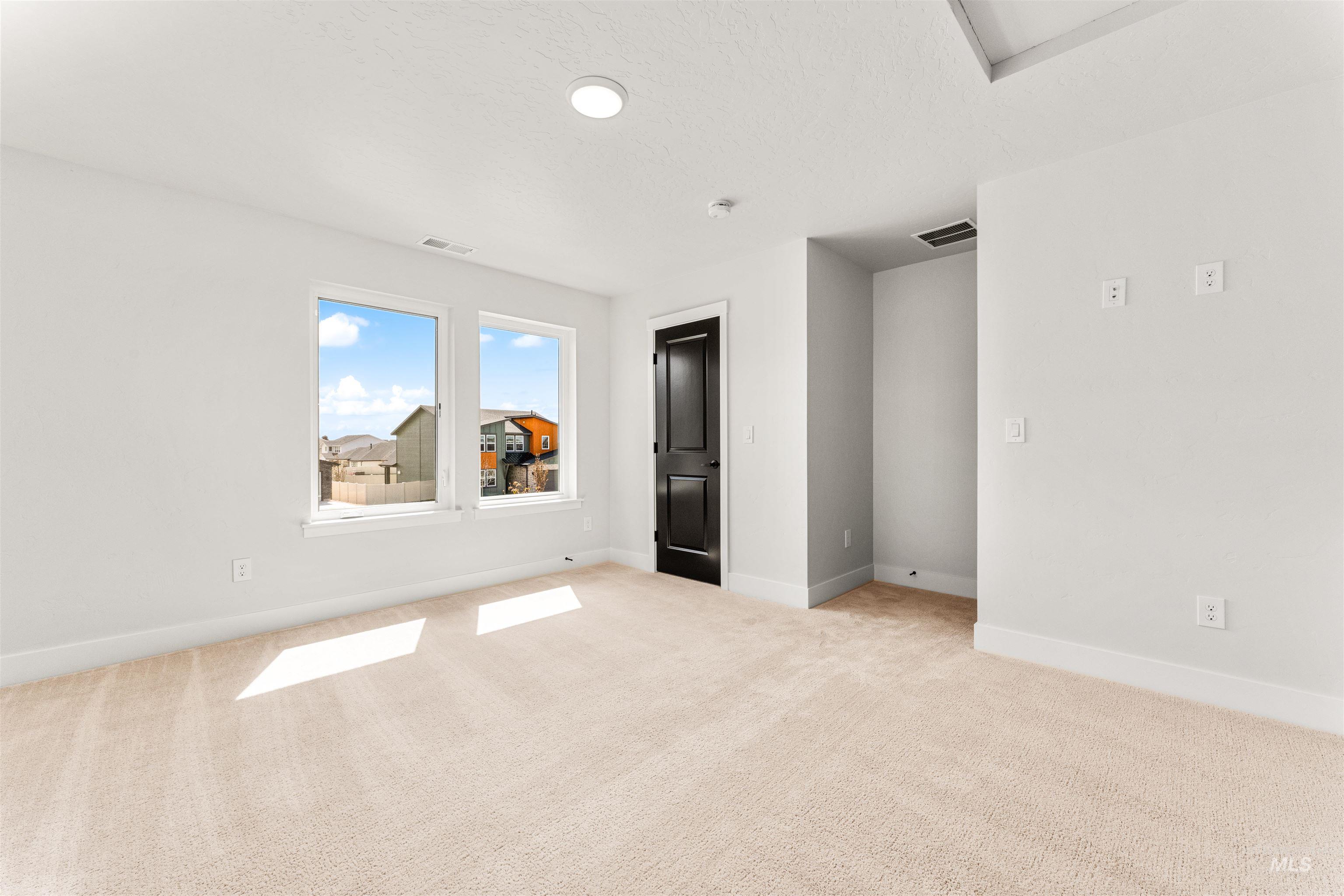 2709 West Gidran Meridian, ID 83642 - Photo 33 of 43 Light-filled room featuring neutral-toned carpeting, white walls, and bright white trim