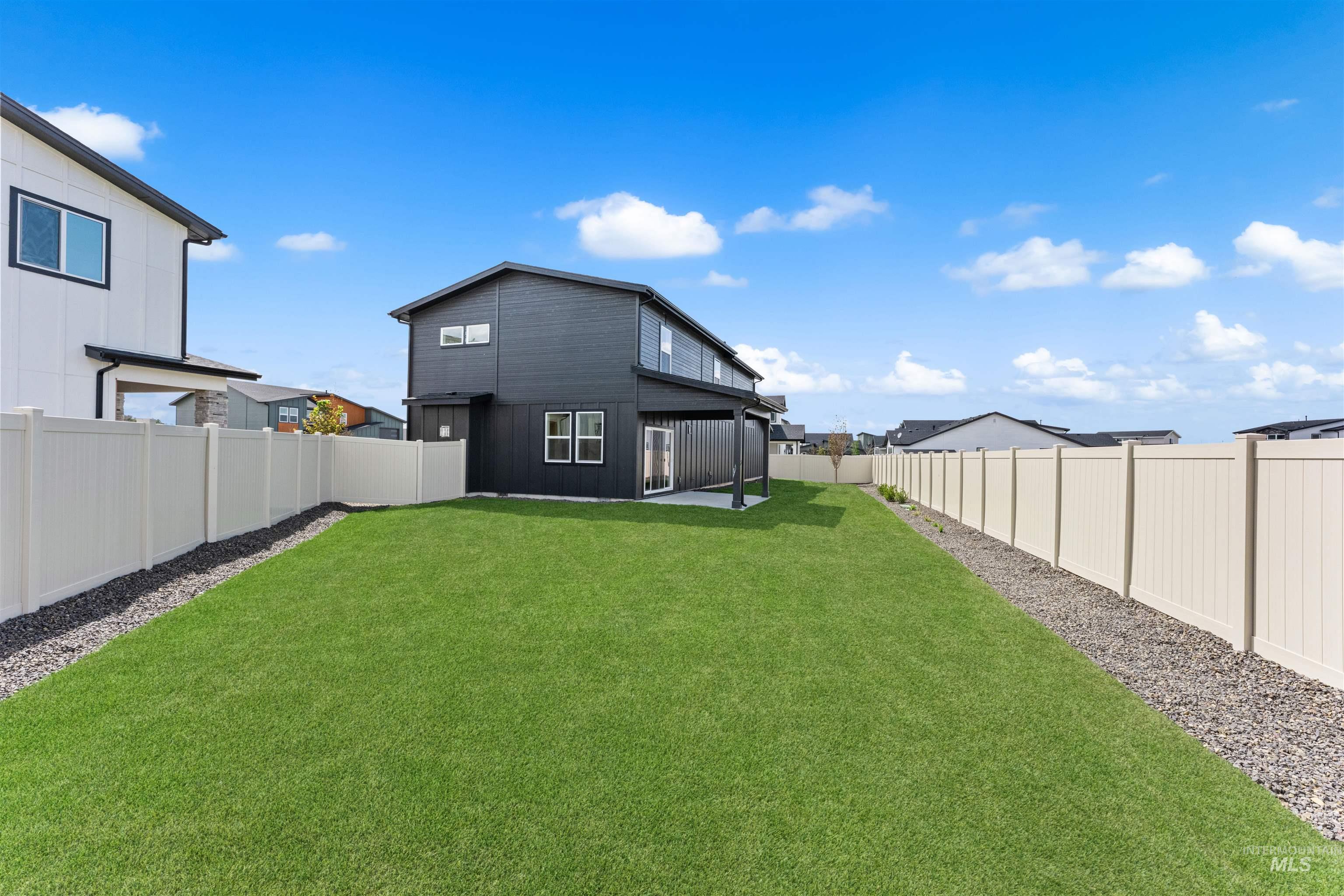 2709 West Gidran Meridian, ID 83642 - Photo 40 of 43 Expansive green lawn framed by light-colored privacy fencing