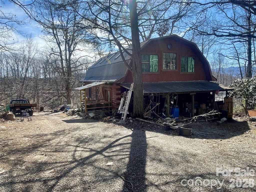 a view of a house with a yard covered with snow