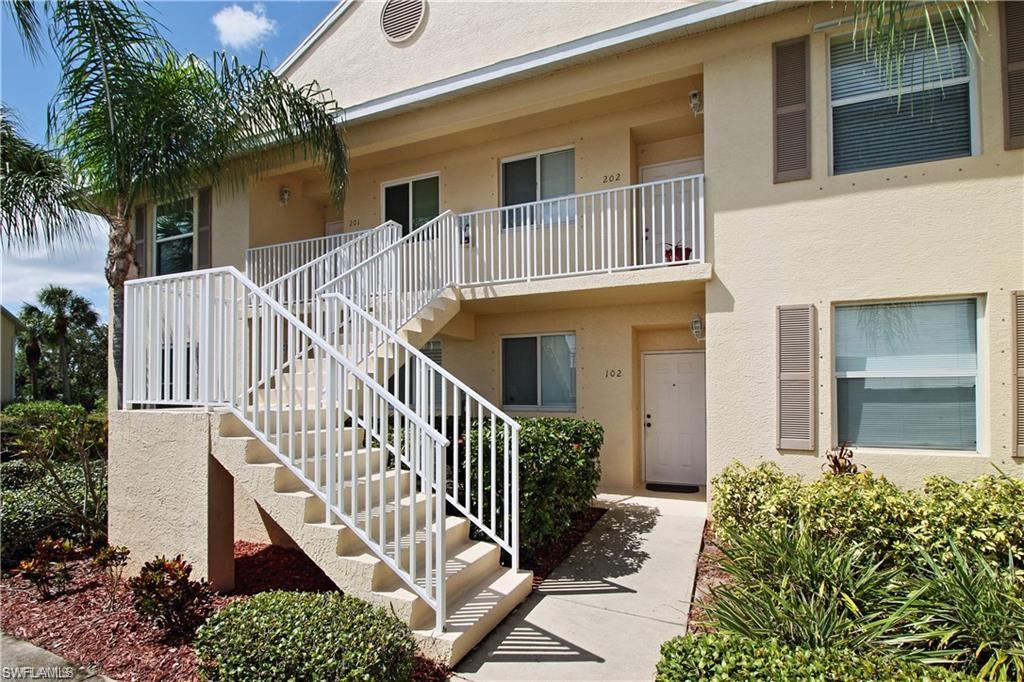 422 Valerie Way, Unit 202 Naples, FL 34104 - Photo 1 of 19 front view of a house with a small yard
