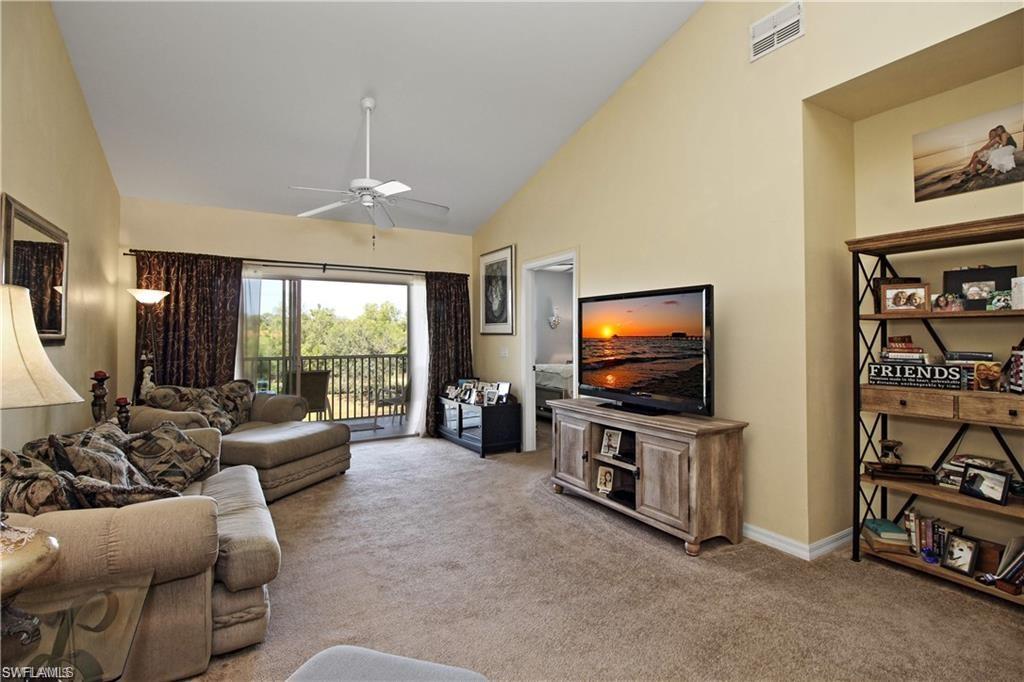 422 Valerie Way, Unit 202 Naples, FL 34104 - Photo 6 of 19 a living room with furniture and a flat screen tv